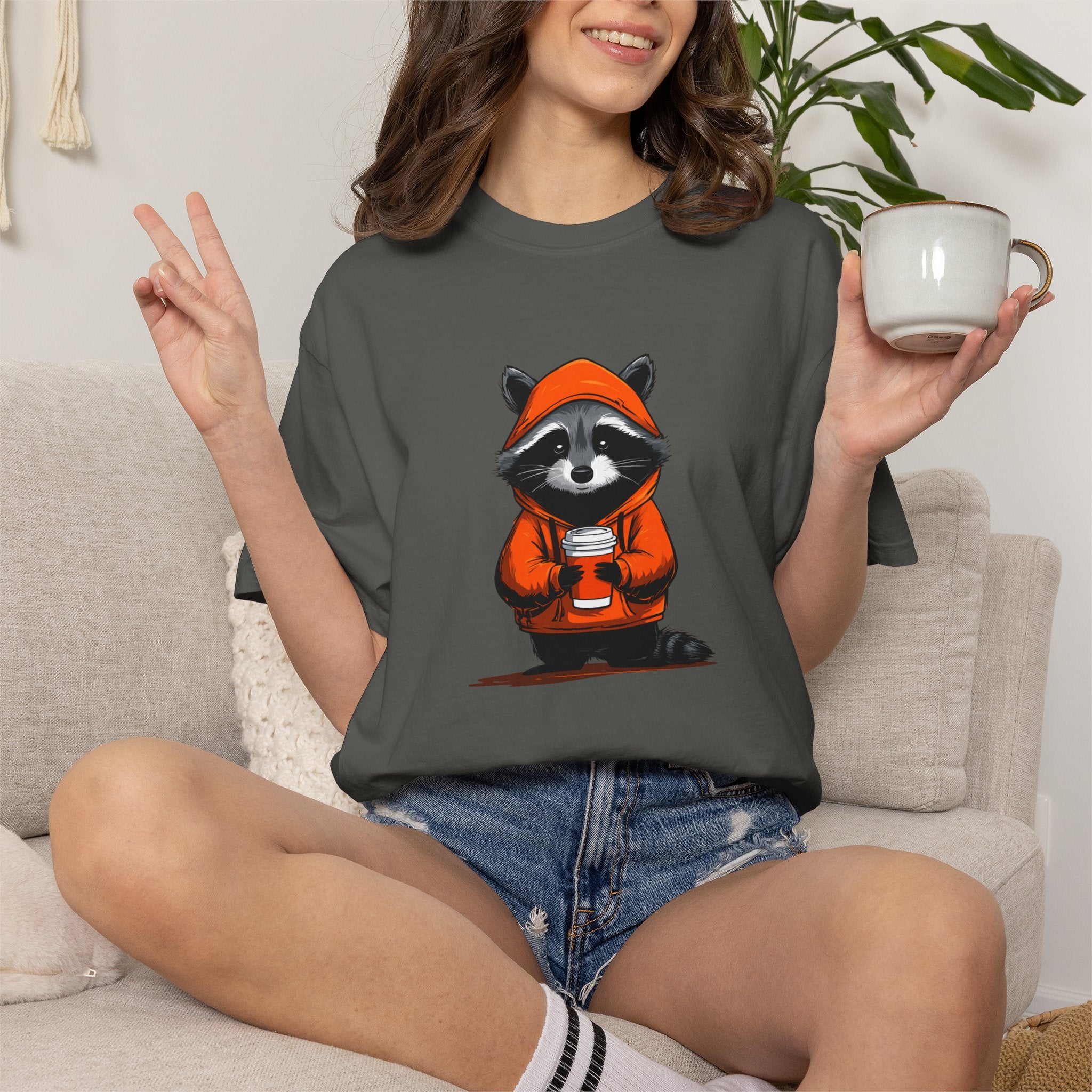 ​"Pepper colored vintage streetwear t-shirt featuring a cute raccoon in an orange hoodie graphic print."