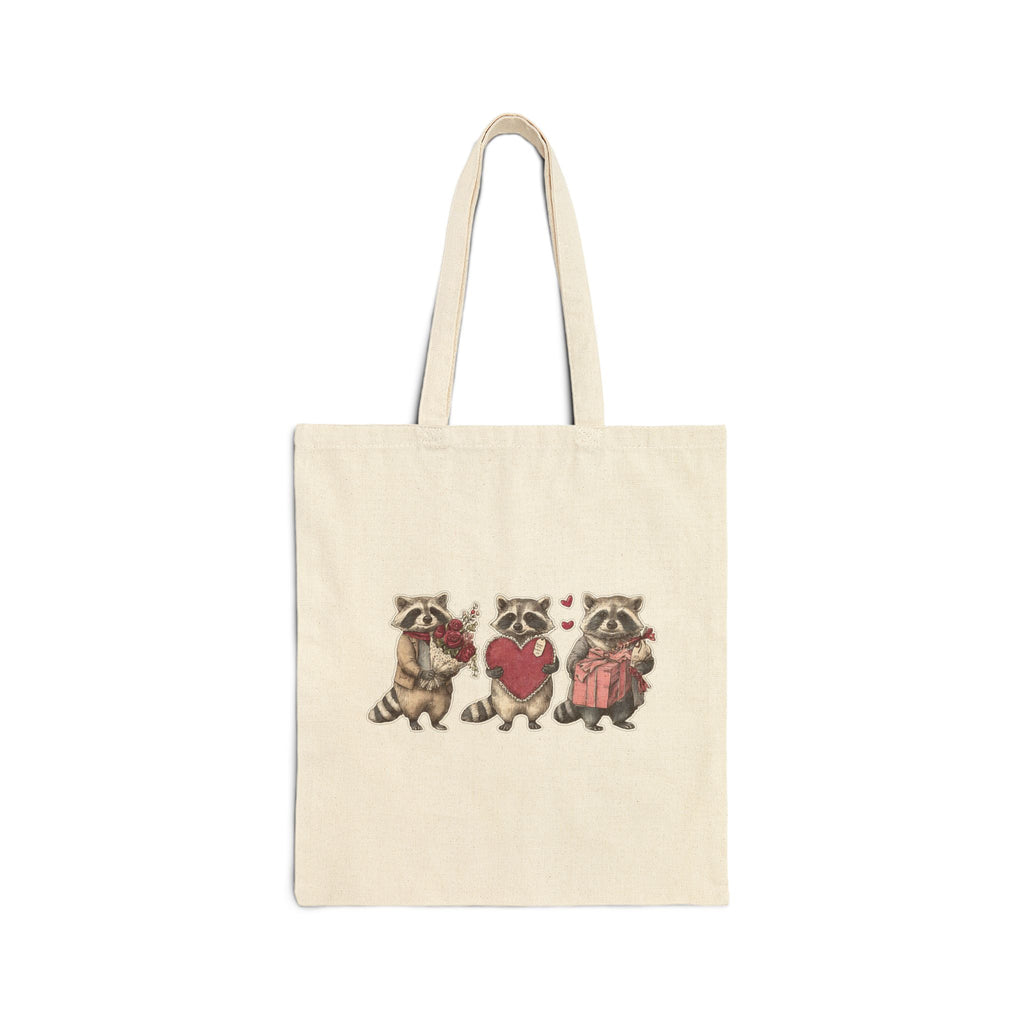 Three raccoons holding heart canvas tote bag, front view
