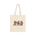 Three raccoons holding heart canvas tote bag, front view