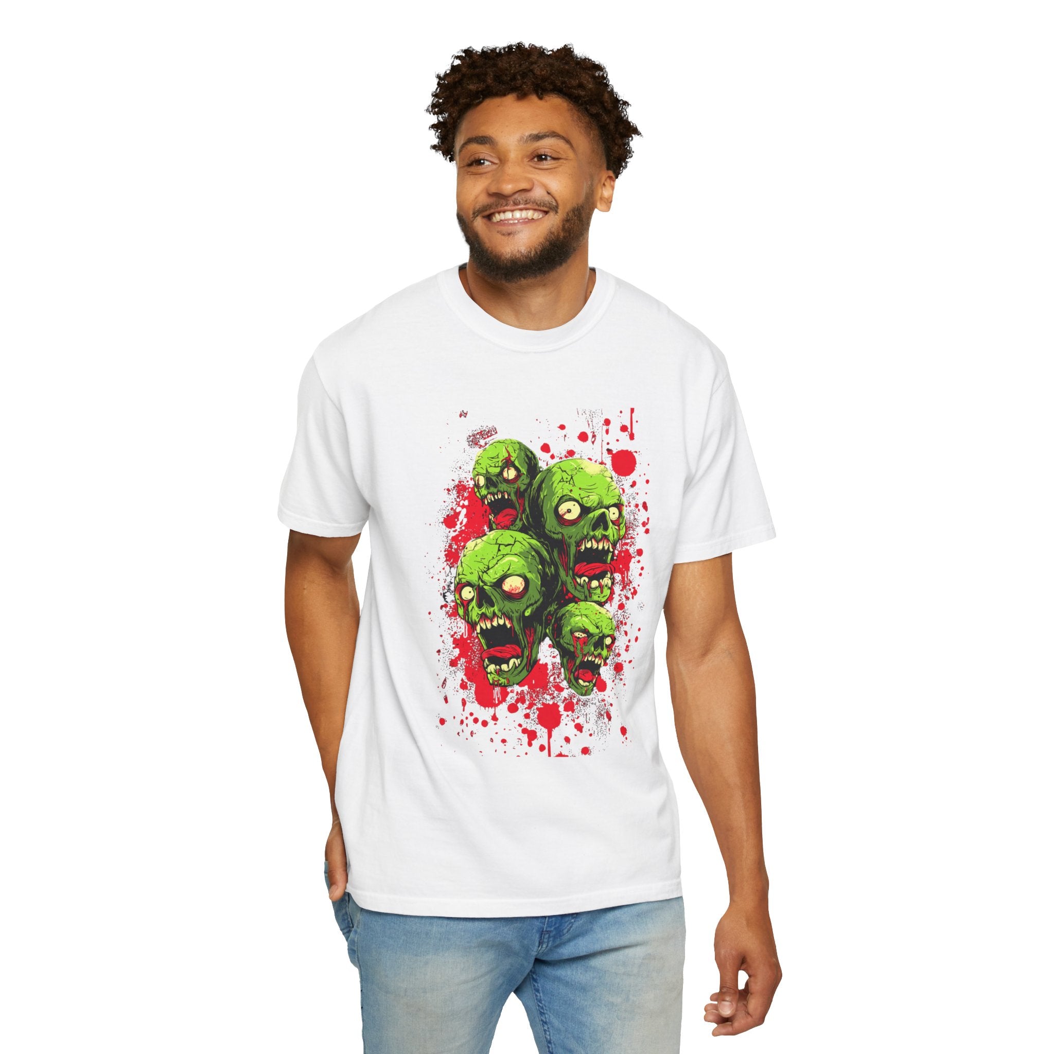​"White streetwear t-shirt featuring a detailed green zombie heads graphic print with red paint splatter effect."