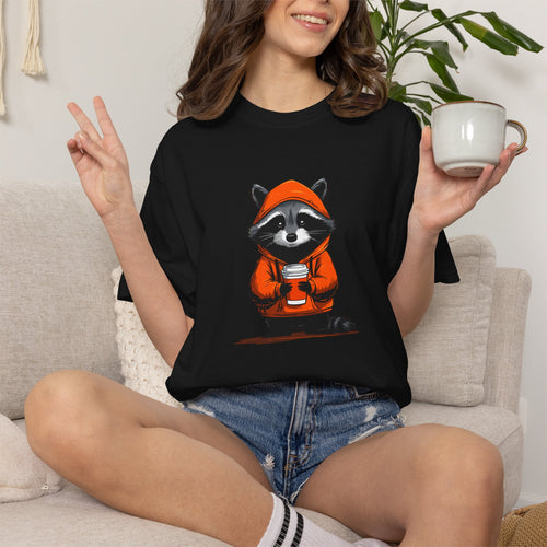 "Black unisex streetwear t-shirt featuring a cute raccoon in an orange hoodie holding a coffee cup."